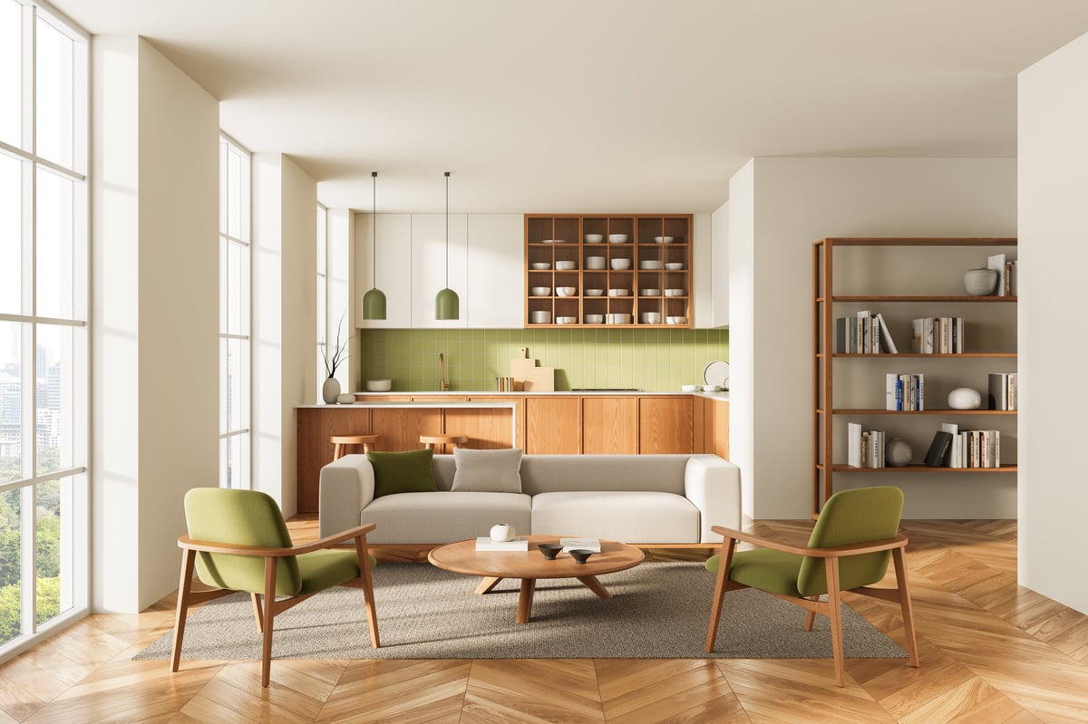 Open-plan basement living room with green chairs