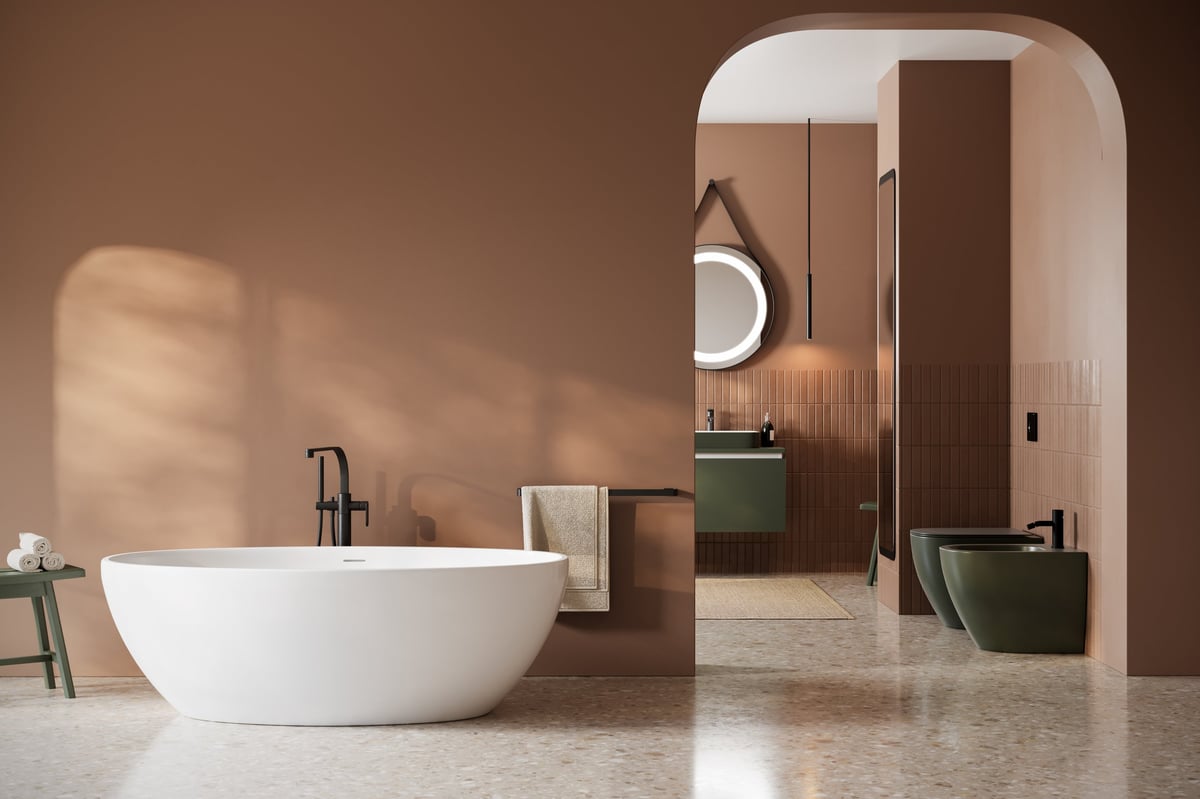 Modern bathroom with arched opening and freestanding tub